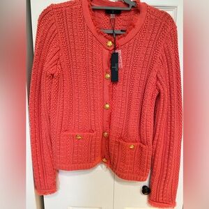 Beautiful orange knit jacket with fringe detail on sleeves and neck.